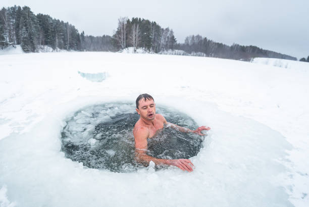 istock Young man swims in the ice hole 1285676063