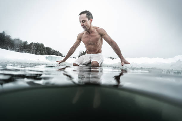 istock Young man swims in the ice hole 1285676837