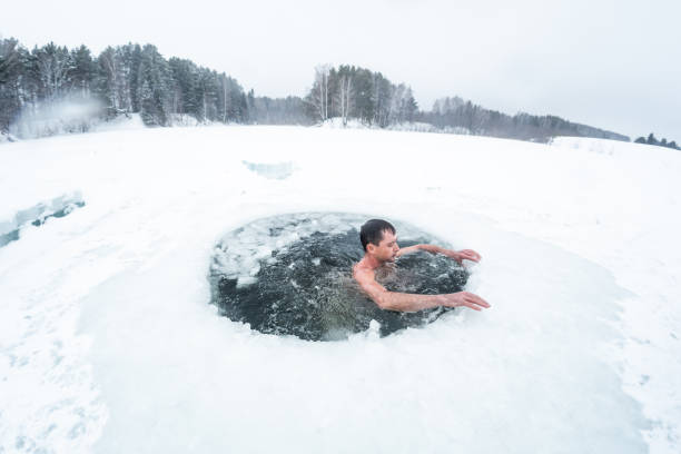 istock Young man swims in the ice hole 1285677391