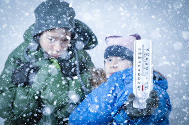 istock Two kids freezing in snowstorm 1285678088