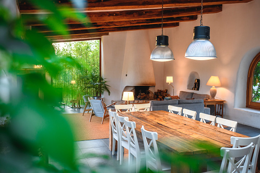 Nice living  and dining room in a house in Spain. Green backyard is in the back.