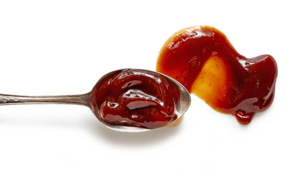 istock spoon of barbecue sauce isolated on white background, top view 1285684704