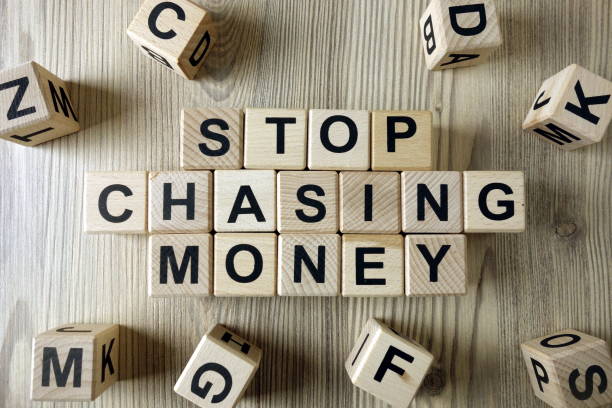 istock Text stop chasing money from wooden blocks 1285684809