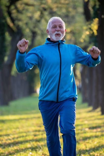 istock Senior man jogging in park in autumn 1285684810