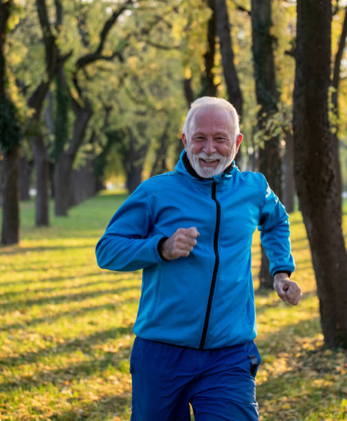 istock Senior man jogging in park in autumn 1285684815