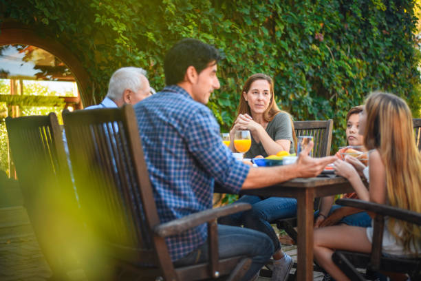 istock Three-Generation Spanish Family Eating Breakfast Outdoors 1285684931