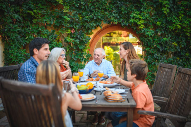 istock Multi-Generation Spanish Family Enjoying Breakfast Outdoors 1285684948