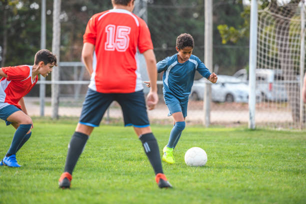 istock Blue Jersey Boy Footballer Controlling Ball in Practice 1285685659