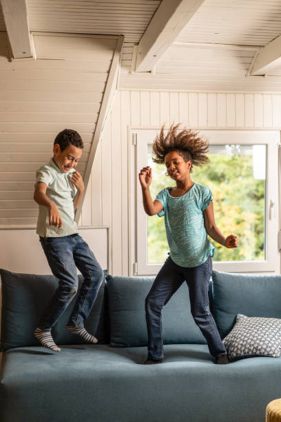 istock Playful African American kids playing at home. 1285687891
