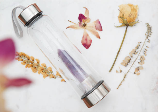 crystal water bottle styling for crystal water bottle with dried flowers crystal photos stock pictures, royalty-free photos & images