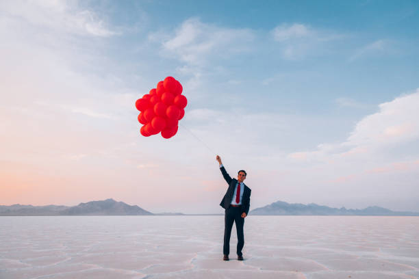 istock Businessman Flying with Balloons 1285689781