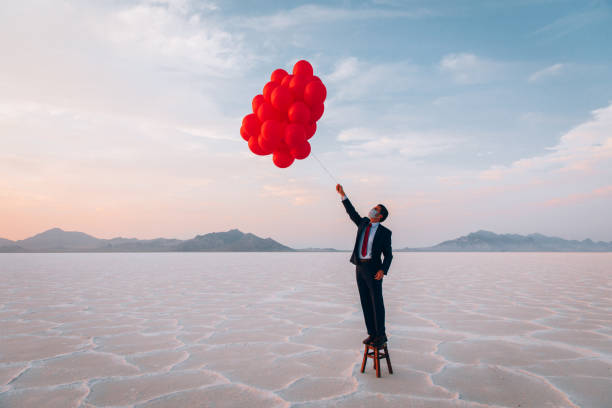 istock Businessman Standing with Balloons 1285689791