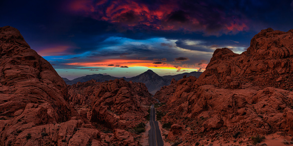 Valley of Fire State Park, Nevada, United States. Aerial panoramic view on the scenic road in the desert during a cloudy twilight. Dramatic Twilight Sky Artistic Render.