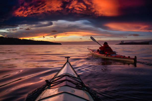 Adventure Man on a Sea Kayak at Sunset