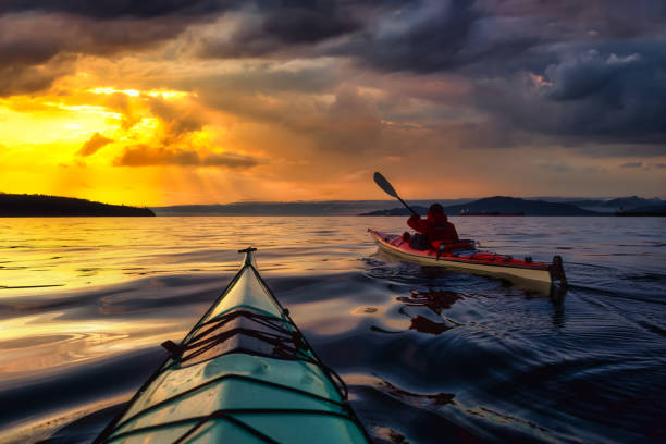 istock Adventure Man on a Sea Kayak at Sunset 1285690999