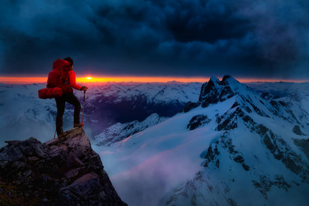 istock Girl Backpacker on top of a Mountain Peak 1285691142