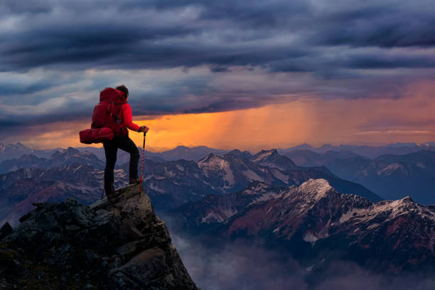 istock Girl Backpacker on top of a Mountain Peak. 1285691189