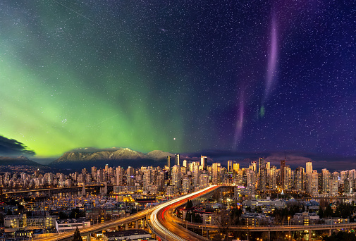 Downtown Vancouver, British Columbia, Canada. Beautiful Aerial Panoramic View of a Modern City. Cityscape Skyline. During Colorful Night with aurora borealis Composite. Dreamscape