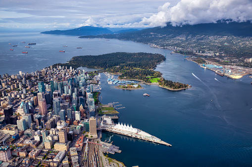 Aerial View of Downtown Vancouver, Coal Harbour and Stanley Park. Taken during a bright sunny morning in British Columbia, Canada. Modern Cityscape from above.