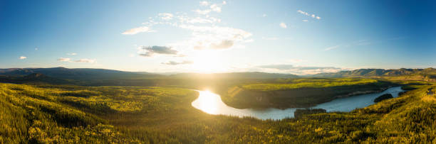 Aerial View of Yukon, Canada Beautiful View of Scenic Valley from Above alongside Winding River, Forest and Mountains at Sunset. Aerial Drone Shot. Taken near Klondike Highway, Yukon, Canada. river valleys stock pictures, royalty-free photos & images