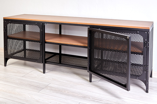 Modern TV stand with metal frame and wooden shelves.