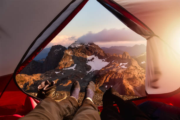 istock Camping inside a Tent with beautiful rocky mountains in the background 1285694294