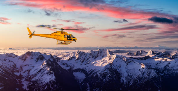 istock Yellow Helicopter flying over the Rocky Mountains 1285694397