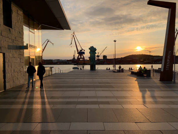 Goteborg, Sweden - June 10, 2019: Walkers in the harbor at sunset