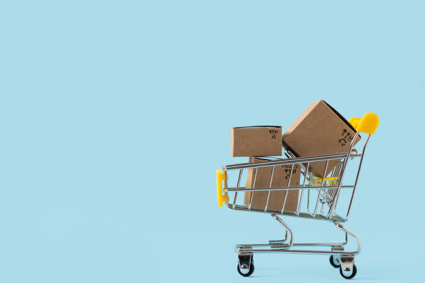 istock Toy shopping cart with boxes on blue background 1285697809