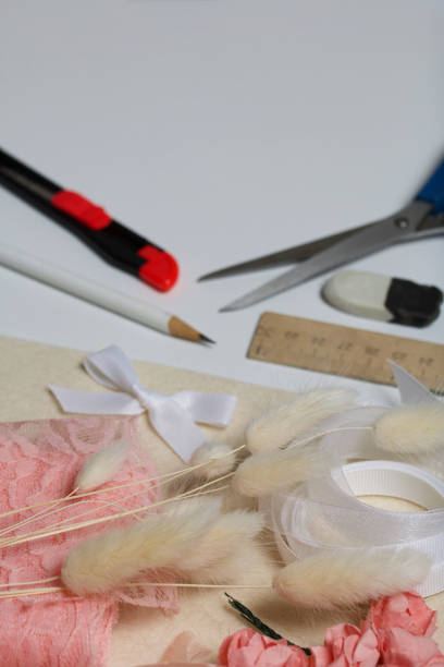 istock Needlework accessories. Dried flowers and ribbons for crafts. Tools for creativity. On a white tabletop. 1285699259