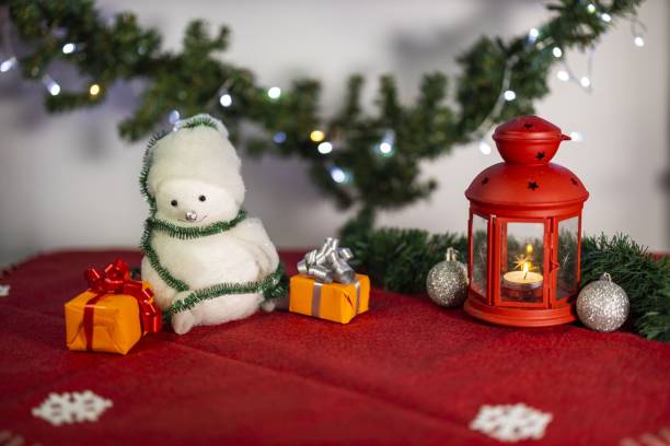 istock Close up view of christmas decoration objects on red carpet on white wall background. Christmas holiday concept. 1285699410