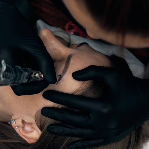 istock Permanent eyebrow makeup procedure. Eyebrow tattooing, process. The use of tools by a master for permanent eyebrow makeup. 1285703643