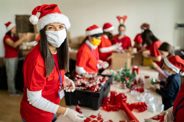 istock Young volunteer helping preparing Christmas gifts 1285703688