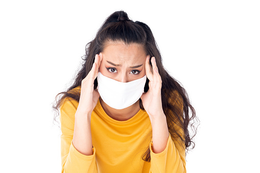 Stress Worry Asian woman wearing hygienic mask to prevent infection corona virus Air pollution pm2.5 she wearing a yellow sweater shoot in isolated on white background