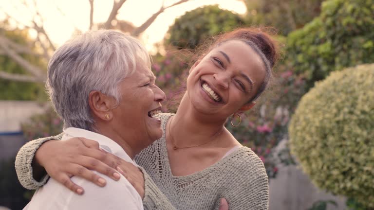 4k video footage of a woman embracing her senior mother while standing outside