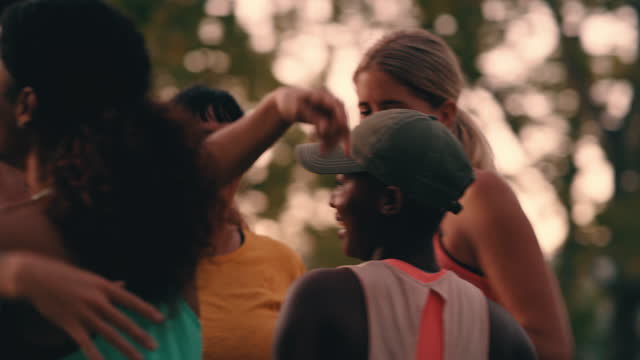 4k video footage of a group of young women hugging after their workout at the park