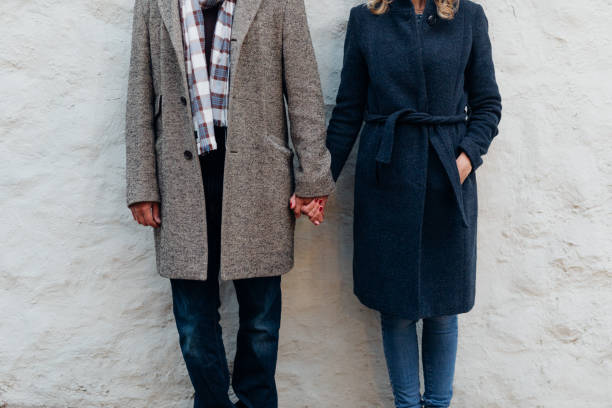 istock Anonymous Couple in Winter Coats Holding Hands, a Close Up 1285709168