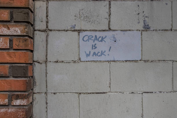 Crack is wack sign Message about drugs being bad. Crack is whack written on a brick wall in graffiti with wrong spelling wack stock pictures, royalty-free photos & images