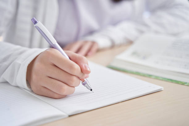 japanese girl at hand doing her living room homework - homework pencil people indoors imagens e fotografias de stock