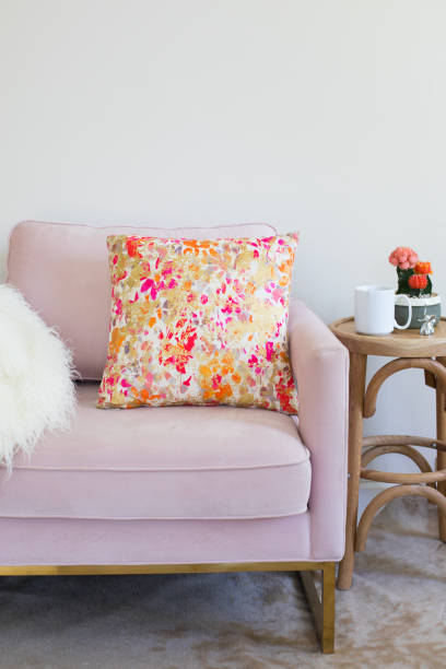 istock Pale Pink Chair with Colorful Throw Pillow and Side Table 1285714733