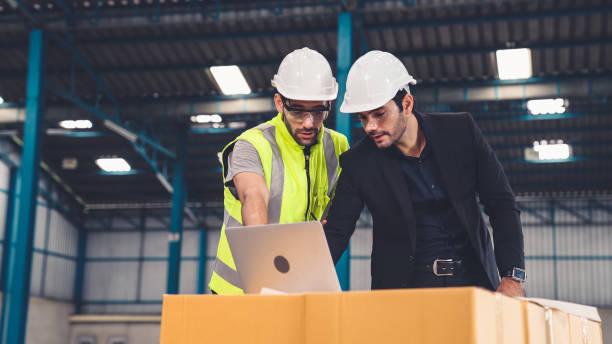 istock Two factory workers working and discussing manufacturing plan in the factory . 1285717775