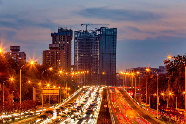 istock Traffic light trails on city roads 1285720270
