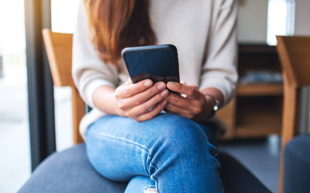 istock a woman holding and using smart phone 1285724369