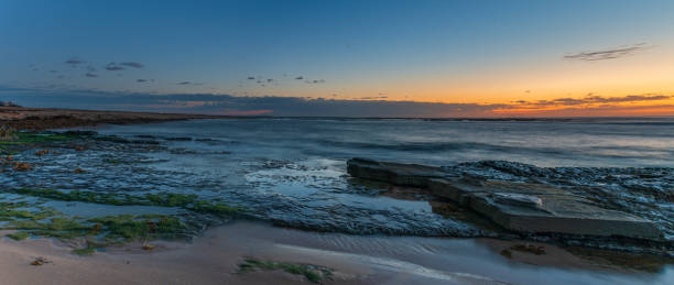 istock Rocky coastline panorama sunrise seascape 1285725193