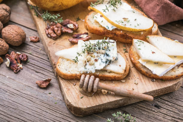 istock Toast or canape  with goat cheese, thyme, honey, nuts.  Delicious appetizer, ideal as an aperitif. 1285726074