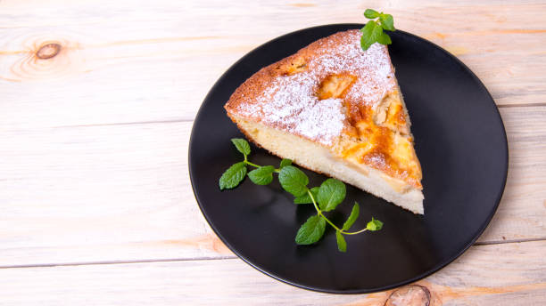 istock Charlotte, Apple pie with mint sprigs in a black plate on a wooden table, copy space, close-up, photos, Wallpaper 1285732207