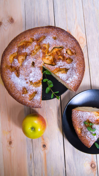istock Charlotte, Apple pie with mint sprigs, Apple in a black plate on a wooden table, copy space, close-up, photos, Wallpaper 1285732220