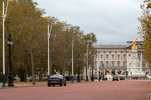 The Mall in City of Westminster, London, with Buckingham Palace and the Victoria Memorial in the background, along with cars