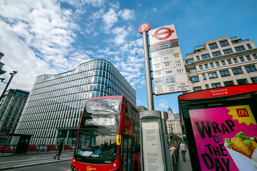 Monument Station Bus Stop in London, England, with a double-decker bus destined for Clapham Junction in the background and commercial elements visible