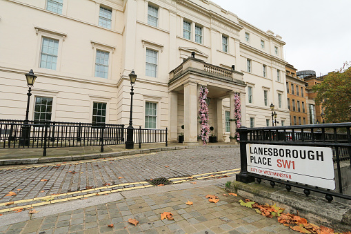 The Lanesborough Hotel was originally St George's Hospital which was founded here in 1733 in a country home built in 1719 by Viscount Lanesborough. The hospital outgrew the site and the building was transformed into Lanesborough Hotel. People can be seen on the sidewalk.